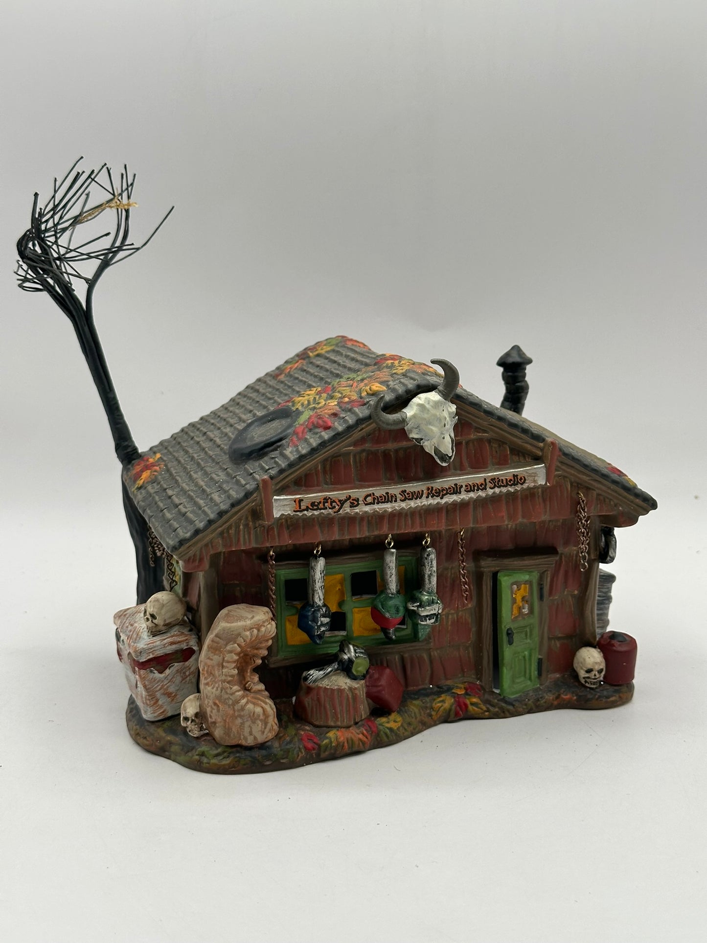 Department 56 - Lefty’s Chain Saw Repair and Studio - Snow Village Halloween